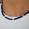 Lapis lazuli beaded necklace with gold-filled accents, featuring the beads strung along the neck.